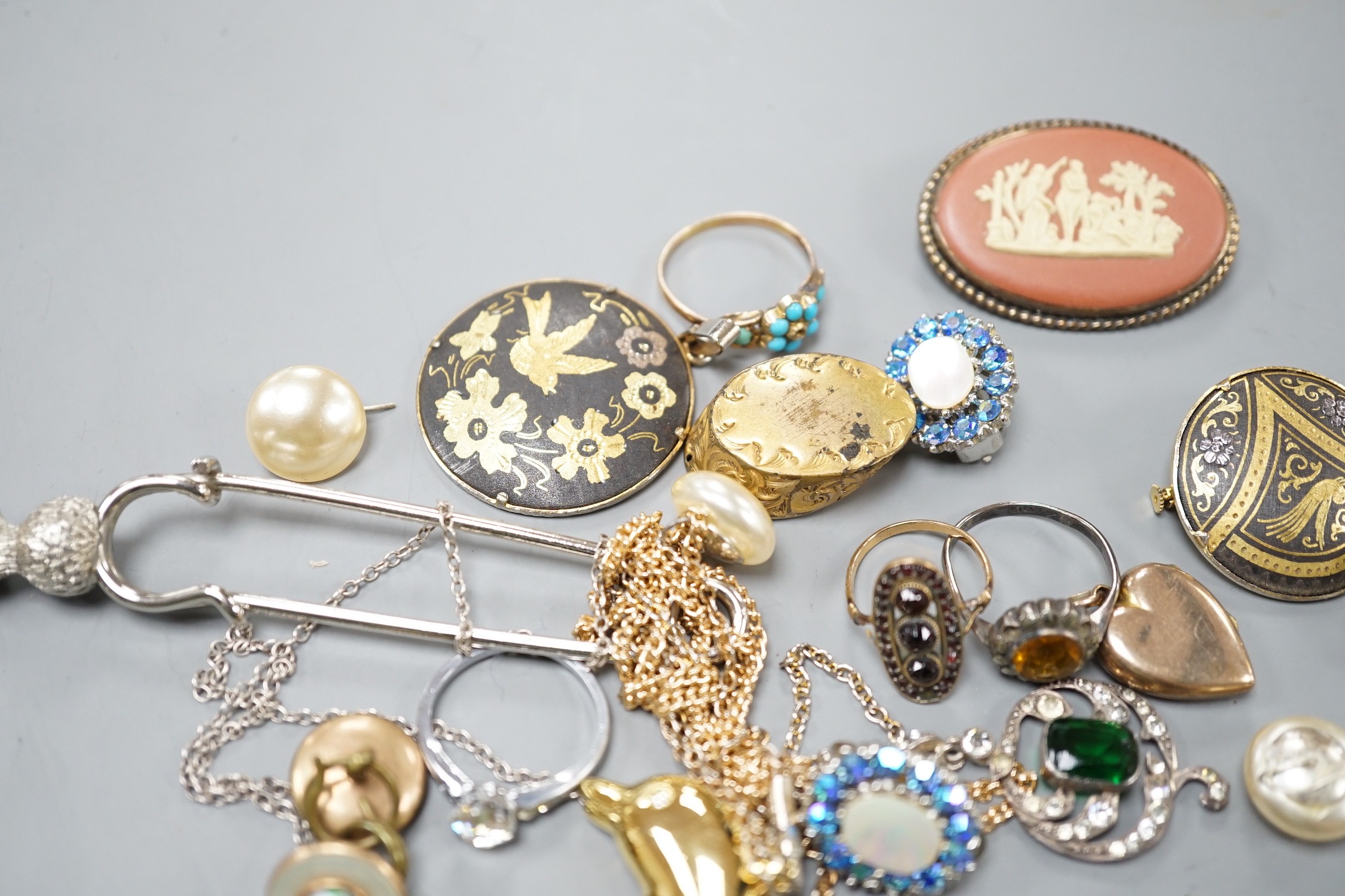 A yellow metal and turquoise cluster set dress ring(stone missing), a similar seed pearl set heart shaped locket and a group of assorted costume jewellery.